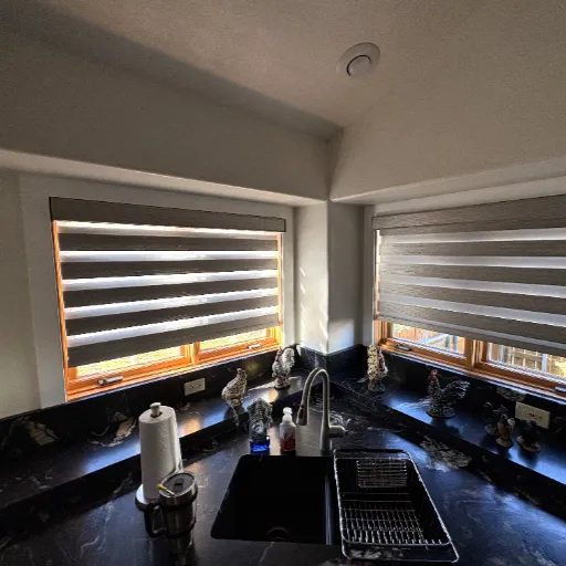 Open blinds with black kitchen countertops